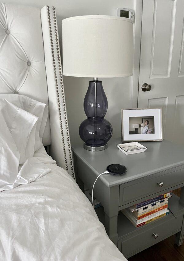 lamp and picture frame on bedside table