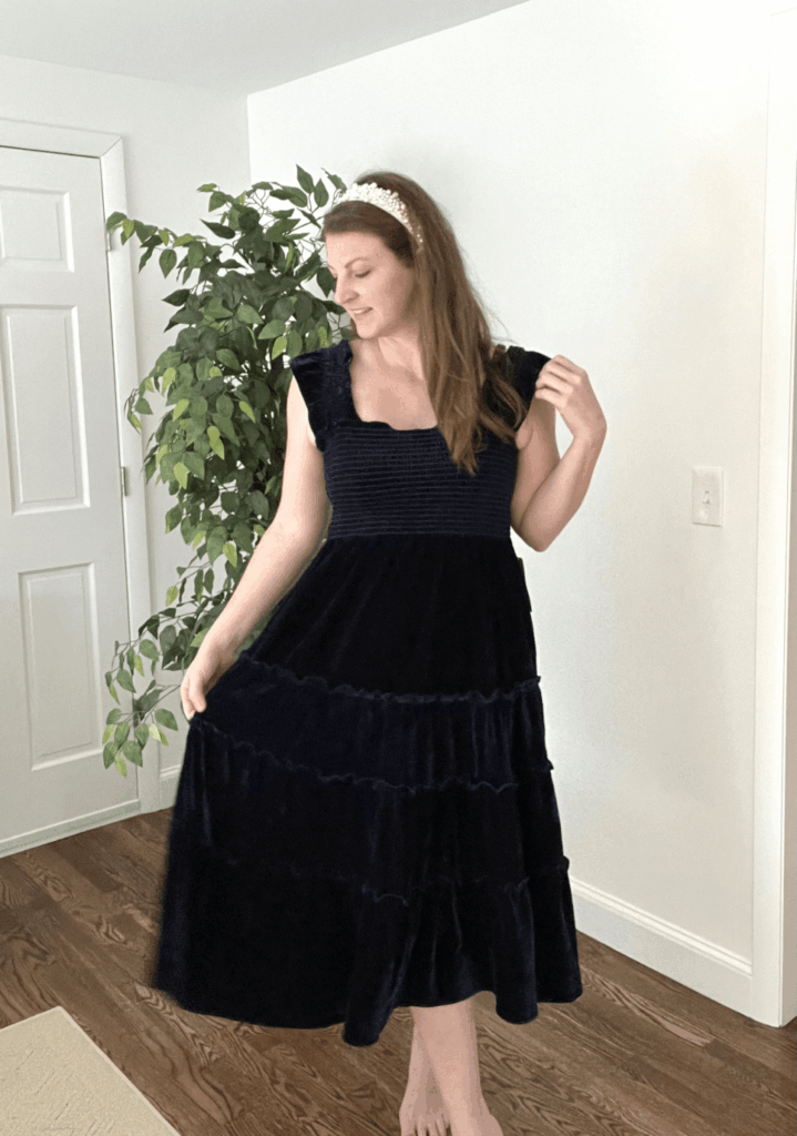 Alyssa Loring wearing Few Moda navy velvet dress with ruffle sleeve